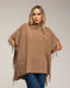 Poncho de punto con flecos en los laterales, cuello perkins y bolsillos.