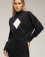 Jersey de punto con rombo y detalles de strass y cuello perkins