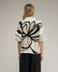 Jersey de punto estampado de flores con lentejuelas y manga francesa.