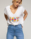 Camiseta con texto "joy" y lentejuelas y abalorios. - Tantra Spain