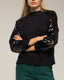 Jersey de punto con mangas de lentejuelas. - Tantra Spain