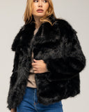 Short faux fur coat with lapel and side pockets