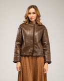 Short reversible jacket in short faux fur with faux suede lining, snap button closure, stand-up collar and pockets