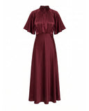 Long satin dress with a turtleneck and bow at the back, fitted at the waist with short flared sleeves