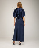 Long satin dress with a turtleneck and bow at the back, fitted at the waist with short flared sleeves