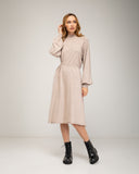 Oversized fine knit dress with a high neck, fitted at the front waist, and elastic cuffs