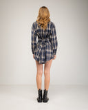 Short checkered shirt dress with lace-up and button details. Drawstrings at the waist