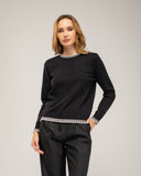 Fine-knit sweater with a crew neck and topstitching at the neck, cuffs, and hem