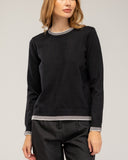 Fine-knit sweater with a crew neck and topstitching at the neck, cuffs, and hem