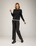 Fine-knit sweater with a crew neck and topstitching at the neck, cuffs, and hem