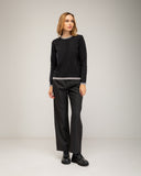 Fine-knit sweater with a crew neck and topstitching at the neck, cuffs, and hem