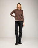Fine-knit sweater with a crew neck and topstitching at the neck, cuffs, and hem