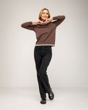 Fine-knit sweater with a crew neck and topstitching at the neck, cuffs, and hem