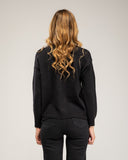 Knitted sweater with a crew neck and embroidered flowers on the chest, neckline and hem
