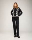 Knitted sweater with a crew neck and embroidered flowers on the chest, neckline and hem