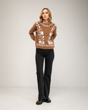 Knitted sweater with a crew neck and embroidered flowers on the chest, neckline and hem