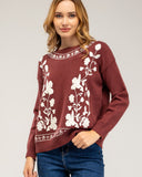 Knitted sweater with a crew neck and embroidered flowers on the chest, neckline and hem