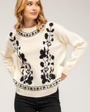 Knitted sweater with a crew neck and embroidered flowers on the chest, neckline and hem