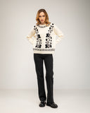 Knitted sweater with a crew neck and embroidered flowers on the chest, neckline and hem