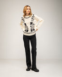 Knitted sweater with a crew neck and embroidered flowers on the chest, neckline and hem