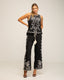 Conjunto de blusa sin mangas y pantalón ancho.