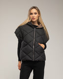 Chaleco acolchado oversize reversible con capucha y bolsillos de cremallera. - Tantra Spain